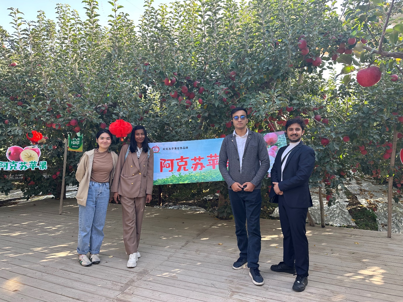 A group of people standing in front of a treeAI-generated content may be incorrect.