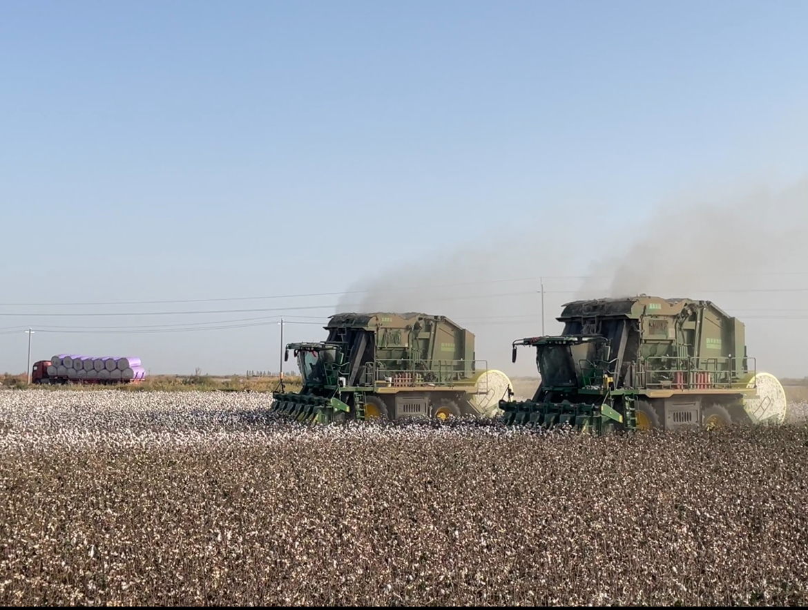A couple of tractors working in a fieldAI-generated content may be incorrect.